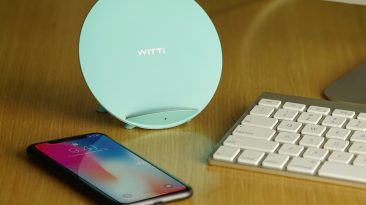 tiffany blue candy wireless charging station on desk next to phone