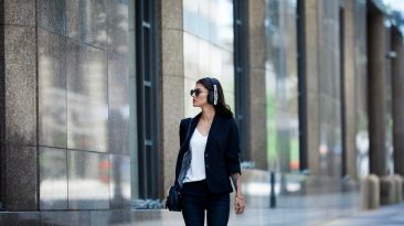 woman walking wearing headphones