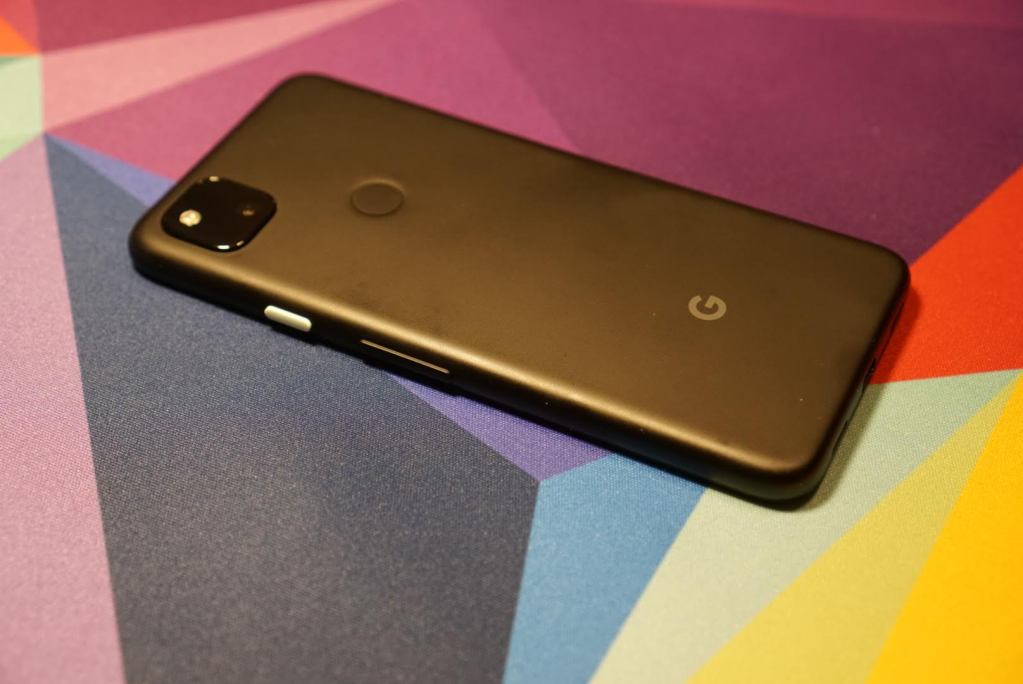 Black smartphone on colorful background.